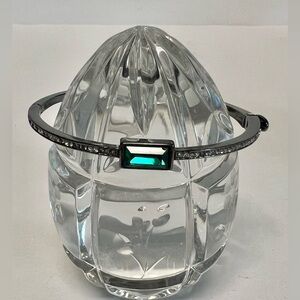 DKNY costume bracelet with center green stone.